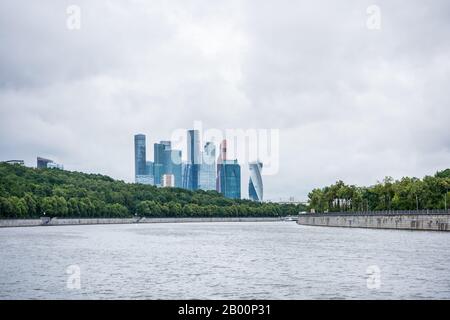 Modern international business center buildings and green forest at sparrow hill at the bank of Moskva River, Moscow, Russia. View form a cruise ship o Stock Photo