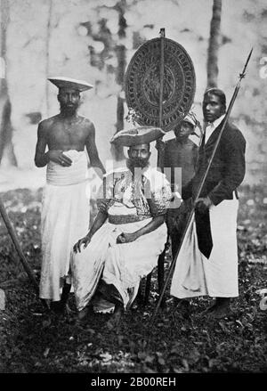 Sri Lanka: A Kandyan chief with his retainers. Photograph by Charles T. Scowen (1852-1948), c. 1870s.  Charles Thomas Scowen (11 March 1852 - 24 November 1948) was a British photographer active during the late nineteenth century, primarily from 1871-1890. He worked out of Sri Lanka and British India with his own established studio, Scowen & Co. His first studio was in Kandy, but he had opened a second in Colombo by the 1890s. His photos were famed for their lighting, strong compositional qualities and technically superior printing. Stock Photo