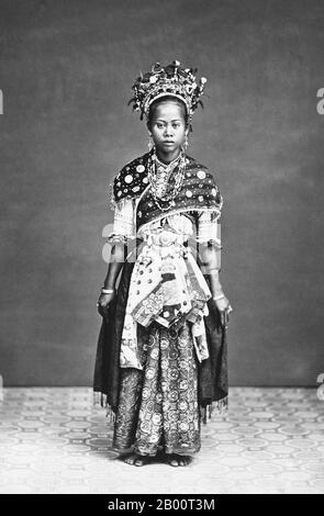 Indonesia: Dancer with a Group of Wandering Puppeteers in Batavia (Jakarta), 19th century.  This dancer was part of a troupe of wandering entertainers who traveled through Java in the late 19th century, performing dances and puppet shows. Indonesian shadow puppetry, known as wayang kulit, is one of the world’s oldest storytelling traditions. Traditional Javanese dance began as a court ritual, but over time the dances incorporated many of the stories and traditions performed in the puppet theater. The photograph was taken by the British studio of Woodbury & Page, which was established in 1857. Stock Photo
