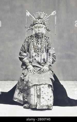 Indonesia: Chinese Bride in Batavia (Jakarta).  This photograph shows a Chinese bride in Batavia (present-day Jakarta) in her wedding dress. The commercial development of Batavia under the Dutch created numerous opportunities for immigrants from China, who became a favored minority and helped to support Dutch colonial rule. While many Chinese immigrants and their descendants adopted Dutch lifestyles by the late 19th century, others continued to identify with China and maintained Chinese customs and traditional dress. The photograph was taken by the studio of Woodbury & Page. Stock Photo