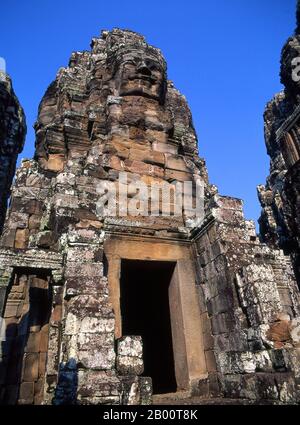 Cambodia: Face tower, the Bayon, Angkor Thom.  Angkor Thom is located one mile north of Angkor Wat. It was built in the late 12th century by king Jayavarman VII, and covers an area of 9 km², within which are located several monuments from earlier eras as well as those established by Jayavarman and his successors. It is believed to have sustained a population of 80,000-150,000 people. At the centre of the city is Jayavarman's state temple, the Bayon, with the other major sites clustered around the Victory Square immediately to the north. Stock Photo