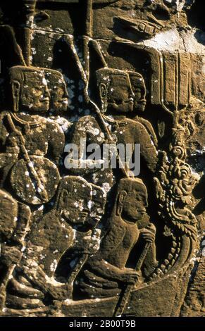 Cambodia: Khmer warriors in a warship approach a Cham warship in a battle on the Tonle Sap, bas-relief, the Bayon, Angkor Thom.  Angkor Thom is located one mile north of Angkor Wat. It was built in the late 12th century by king Jayavarman VII, and covers an area of 9 km², within which are located several monuments from earlier eras as well as those established by Jayavarman and his successors. It is believed to have sustained a population of 80,000-150,000 people. At the centre of the city is Jayavarman's state temple, the Bayon, with the other major sites clustered around the Victory Square. Stock Photo