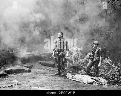 Vietnam: Weary American soldiers pause for reflection during the battle of Long Khanh, 1966.  The Second Indochina War, known in the USA as the Vietnam War, was a Cold War era military conflict that occurred in Vietnam, Laos, and Cambodia from 1 November 1955 to the fall of Saigon on 30 April 1975.   The war followed the First Indochina War and was fought between North Vietnam, supported by its communist allies, and the government of South Vietnam, supported by the US. and other anti-communist nations. Stock Photo