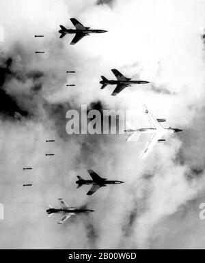 Vietnam: Flying with a B-66 Destroyer, USAF F-105 Thunderchiefs bomb a target through low clouds over North Vietnam, 14 June 1966.  Flying under radar control with a B-66 Destroyer, Air Force F-105 Thunderchief pilots bomb a military target through low clouds over the southern panhandle of North Vietnam.  June 14, 1966.  Public Domain image by Lt. Col. Cecil J. Poss, USAF. Stock Photo