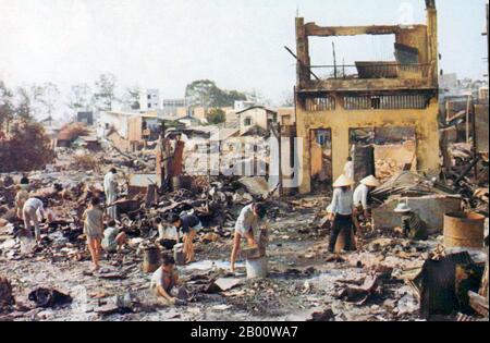 Vietnam: Local people in Cholon picking through the wreckage after the destruction caused by the Tet Offensive of 1968.  The Second Indochina War, known in America as the Vietnam War, was a Cold War era military conflict that occurred in Vietnam, Laos, and Cambodia from 1 November 1955 to the fall of Saigon on 30 April 1975. This war followed the First Indochina War and was fought between North Vietnam, supported by its communist allies, and the government of South Vietnam, supported by the U.S. and other anti-communist nations. Stock Photo