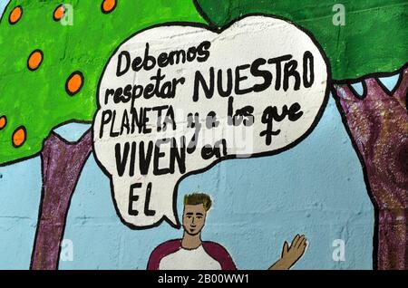 Colorful painting on a wall with a text in spanish "We have to respect our planet and the people who live on" Stock Photo