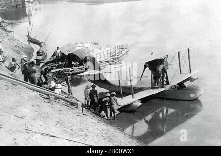 Laos: Vientiane mail is loaded onto a hydroplane on the Mekong River for delivery to Paklay and Luang Prabang, 1930.  The River Mekong is the world's 12th-longest river. From its Himalayan source on the Tibetan plateau, it flows some 4,350 km (2,703 miles) through China's Yunnan province, Burma, Laos, Thailand, Cambodia and Vietnam, finally draining in the South China Sea. The recent construction of hydroelectric dams on the river and its tributaries has reduced the water flow dramatically during the dry season in Southeast Asia. Stock Photo