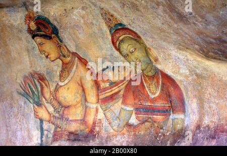 Sri Lanka: Sigiriya's 'Cloud Maidens' adorn the rock face high up over the surrounding countryside.  Sigiriya (Lion's rock) is an ancient rock fortress and palace ruin situated in the central Matale District of Sri Lanka, surrounded by the remains of an extensive network of gardens, reservoirs, and other structures. Sigiriya was built during the reign of King Kasyapa I (CE 477 – 495) and after his death it was used as a Buddhist monastery until the 14th century. Stock Photo