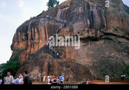 Sri Lanka: Visitors climbing Sigiriya (Lion's Rock).  Sigiriya (Lion's Rock) was built during the reign of King Kasyapa I (CE 477 – 495), and is a World Heritage Site. Stock Photo