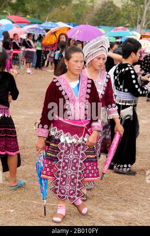 Two women in Hmong festival attire pose for a photo at the New Year