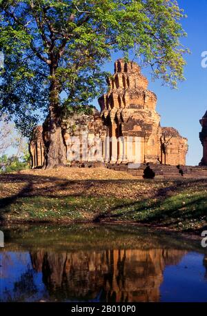 Thailand: The brick prangs of Prasat Sikhoraphum, Surin Province, Northeast Thailand.  Prasat Sikhoraphum is a Khmer Hindu temple built in the 12th century by King Suryavarman II (r. 1113 - 1150).  Prasat Sikhoraphum dates from the early 12th century and has been beautifully restored. It consists of five brick prangs on a square laterite platform surrounded by lily-filled ponds. The lintel and pillars of the central prang are beautifully carved with heavenly dancing girls, or apsara, and other scenes from Hindu mythology. Stock Photo