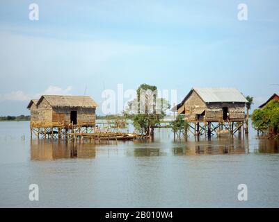 Cambodia: Fishing community and stilted houses on the Great Lake, Tonle Sap.  The Tonlé Sap (Large Fresh Water River or Great Lake) is a combined lake and river system of major importance to Cambodia.  The Tonlé Sap is the largest freshwater lake in South East Asia and is an ecological hot spot that was designated as a UNESCO biosphere in 1997.  The Tonlé Sap is unusual for two reasons: its flow changes direction twice a year, and the portion that forms the lake expands and shrinks dramatically with the seasons. From November to May, Cambodia's dry season, the Tonlé Sap drains into the Mekong. Stock Photo
