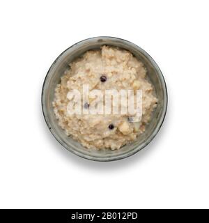 A bowl of nutritious blueberry and apple porridge isolated on white, with a drop shadow Stock Photo