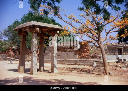 India: Monument near the Vitthala Temple, Hampi, Karnataka State.  Hampi is a village in northern Karnataka state. It is located within the ruins of Vijayanagara, the former capital of the Vijayanagara Empire. Predating the city of Vijayanagara, it continues to be an important religious centre, housing the Virupaksha Temple, as well as several other monuments belonging to the old city. Stock Photo