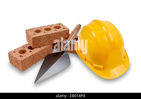 A set of house building bricks and trowel, with a yellow hard hat, isolated on a white background with a drop shadow Stock Photo