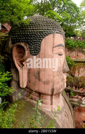 China: Dafo (Giant Buddha), Leshan, Sichuan Province.  The Leshan Giant Buddha (Lèshān Dàfó) was built during the Tang Dynasty (618–907 CE). It is carved out of a cliff face that lies at the confluence of the Minjiang, Dadu and Qingyi rivers in the southern part of Sichuan province in China, near the city of Leshan. The stone sculpture faces Mount Emei, with the rivers flowing below his feet. It is the largest carved stone Buddha in the world and at the time of its construction was the tallest statue in the world. Stock Photo