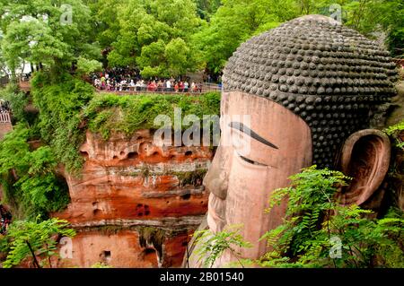China: Dafo (Giant Buddha), Leshan, Sichuan Province.  The Leshan Giant Buddha (Lèshān Dàfó) was built during the Tang Dynasty (618–907 CE). It is carved out of a cliff face that lies at the confluence of the Minjiang, Dadu and Qingyi rivers in the southern part of Sichuan province in China, near the city of Leshan. The stone sculpture faces Mount Emei, with the rivers flowing below his feet. It is the largest carved stone Buddha in the world and at the time of its construction was the tallest statue in the world. Stock Photo