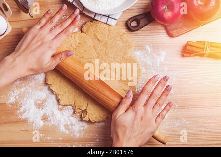 Woman's hands rolling dough for apple pie Stock Photo