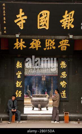 China: Entrance to Baoguo Si (Declare Nation Temple), at the foot of Emeishan (Mount Emei), Sichuan Province.  Baoguo Si (Declare Nation Temple), at the foot of Mount Emei, was first constructed in the 16th century during the Ming Dynasty (1368-1644).  At 3,099 metres (10,167 ft), Mt. Emei is the highest of the Four Sacred Buddhist Mountains of China. The patron bodhisattva of Emei is Samantabhadra, known in Chinese as Puxian. 16th and 17th century sources allude to the practice of martial arts in the monasteries of Mount Emei. Stock Photo