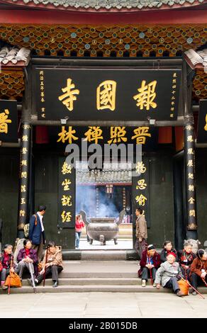 China: Entrance to Baoguo Si (Declare Nation Temple), at the foot of Emeishan (Mount Emei), Sichuan Province.  Baoguo Si (Declare Nation Temple), at the foot of Mount Emei, was first constructed in the 16th century during the Ming Dynasty (1368-1644).  At 3,099 metres (10,167 ft), Mt. Emei is the highest of the Four Sacred Buddhist Mountains of China. The patron bodhisattva of Emei is Samantabhadra, known in Chinese as Puxian. 16th and 17th century sources allude to the practice of martial arts in the monasteries of Mount Emei. Stock Photo