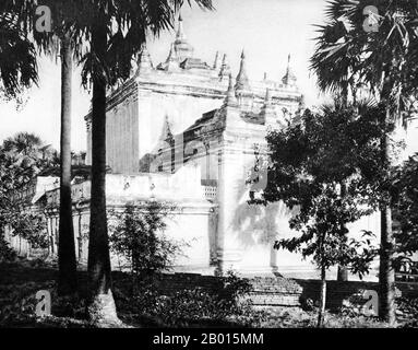 Burma/Myanmar: Manuha temple in Bagan, Upper Burma, c. 1920s.   Manuha Temple is a Buddhist temple built in Myinkaba (located near Bagan), by King Manuha, the last Talaing king, in 1059-1067. It is a rectangular building of two storeys. The building contains three images of seated Buddhas and an image of Buddha entering Nirvana. Manuha Temple is one of the oldest temples in Bagan.  The ruins of Bagan (also spelled Pagan) cover an area of 16 square miles (41 km2). The majority of its buildings were built between the 11th and 13th centuries. Stock Photo