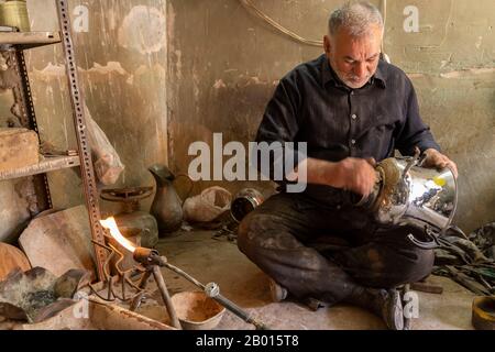 Damghan, Iran - May 25, 2019: Portait of Iranian worker in his littele blacksmith shop, Damghan, Iran. Stock Photo