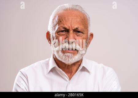 Portrait of senior man who is worried and disappointed. Stock Photo