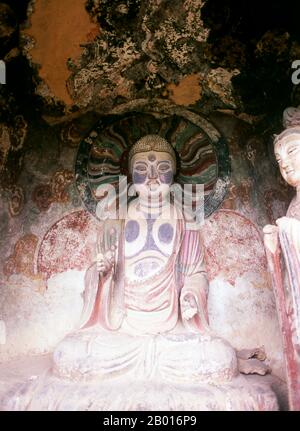 China: Buddha, Maiji Shan Grottoes, Tianshui, Gansu Province.  Maijishan Shiku (Maiji Shan Grottoes) are one of China’s four most important Buddhist temple groups (the others being Datong, Luoyang, and the Mogao Caves at Dunhuang).  Starting from the Northern Wei (386-535) and Northern Zhou (557-81) Dynasties, Buddhists cut caves into the sides of a red outcrop rising from the surrounding foliage-covered hills. Figures of the Buddha, of bodhisattvas and disciples were carved in harder rock brought from elsewhere, and installed in the caves. Stock Photo