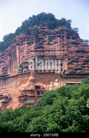 China: Maiji Shan Grottoes, Tianshui, Gansu Province.  Maijishan Shiku (Maiji Shan Grottoes) are one of China’s four most important Buddhist temple groups (the others being Datong, Luoyang, and the Mogao Caves at Dunhuang).  Starting from the Northern Wei (386-535) and Northern Zhou (557-81) Dynasties, Buddhists cut caves into the sides of a red outcrop rising from the surrounding foliage-covered hills. Figures of the Buddha, of bodhisattvas and disciples were carved in harder rock brought from elsewhere, and installed in the caves. Stock Photo