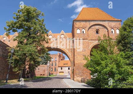 Part of the old city wall of Torun with a defence tower and Teutonic castle, Poland. Stock Photo
