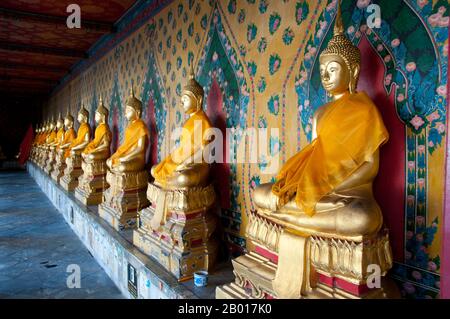 Thailand: A row of Buddhas in the main temple complex, Wat Arun (Temple of Dawn), Bangkok.  Wat Arun Rajwararam (Temple of the Dawn), full name Wat Arunratchawararam Ratchaworamahawihan, is a Thai Buddhist temple on the Thonburi west bank side of the Chao Phraya River in Bangkok. It is named after Aruna, the Indian God of Dawn. A monastery has stood here since the Ayutthayan period (1351 - 1767), but the temple's outstanding feature, the Khmer-style central prang, was not begun until 1809, during the reign of King Buddha Loetla Nabhalai (Rama II). Stock Photo