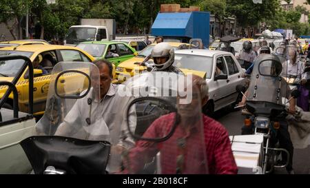 Teheran, Iran - May 21, 2019: Heavy traffic with cars, motorcycles and scooters in air polluted Teheran, Iran. Stock Photo