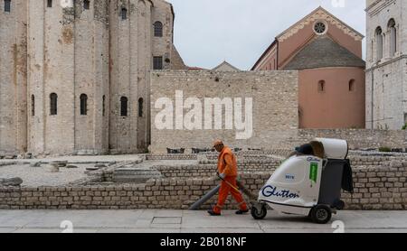 Zadar, Croatia - April 23, 2019: Worker cleaning the streets with an big street vacuum cleaner. Stock Photo