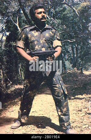 Sri Lanka: LTTE Comander Velupillai Prabhakaran (26 November 1954 - 18 May 2009) posing with a machine gun somewhere in the Wanni, northern Sri Lanka, c. 1985.  Velupillai Prabhakaran was the founder and leader of the Liberation Tigers of Tamil Eelam (the LTTE or the Tamil Tigers), a militant organization that sought to create an independent Tamil state in the north and east of Sri Lanka. For over 25 years, the LTTE waged a violent secessionist campaign in Sri Lanka that led to it being designated a terrorist organisation by 32 countries. Stock Photo