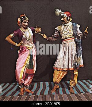 India: Male and female Bharatanatyam dancers in costume, c. 1910.  Bharata Natyam comes from the words Bhava (Expression), Raga (Music), Tala (Rhythm) and Natya (Classic Indian Musical Theatre). Today, it is one of the most popular and widely performed dance styles in India.  Bharata Natyam is considered to be a 'fire dance' — the mystic manifestation of the metaphysical element of fire in the human body. It is one of the five major styles (one for each element) that include Odissi (element of water), Mohiniattam (element of air), Kuchipudi (element of earth) and Kathakali (element of sky). Stock Photo