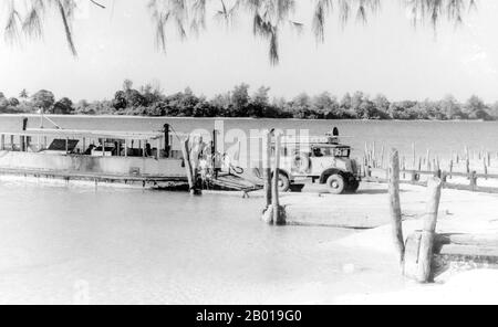 Thailand: A ferry brings cars from the mainland to northern Phuket, 1952.  Phuket, formerly known as Talang and, in Western sources, Junk Ceylon (a corruption of the Malay Tanjung Salang, i.e. 'Cape Salang'), is one of the southern provinces (changwat) of Thailand. Neighbouring provinces are (from north clockwise) Phang Nga and Krabi, but as Phuket is an island there are no land boundaries.  Phuket, which is approximately the size of Singapore, is Thailand’s largest island. The island is connected to mainland Thailand by two bridges. It is situated off the west coast in the Andaman Sea. Stock Photo