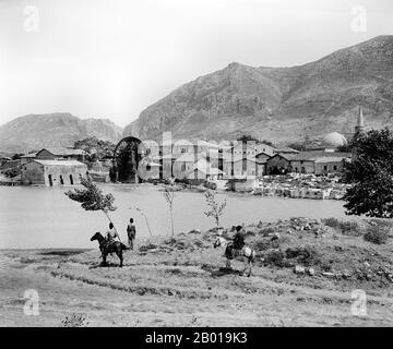 Turkey: Giant waterwheel (noria) on the Orontes ('Asi') River at Antioch, c. 1898.  Antioch, also known as Antioch on the Orontes and Syrian Antioch, was a Hellenistic city located near the current city of Antakya, on the Eastern side of the Orontes River. It was founded near the end of the 4th century BCE by Seleucus I Nicator, a general serving under Alexander the Great. Its location saw it grow in influence and power, becoming one of the most important cities in the Roman Empire, though its influence would decline during the Middle Ages due to various factors. Stock Photo