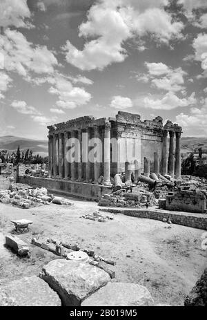 Lebanon: The Temple of Bacchus at Baalbek seen from the northwest, c. 1900.  The Temple of Bacchus was one of the three main temples at a large complex in Classical Antiquity, at Baalbek in Lebanon. The temple was dedicated to Bacchus (also known as Dionysus), the Roman god of wine, but was traditionally referred to by Neoclassical visitors as the 'Temple of the Sun'. It is considered one of the best preserved Roman temples in the world. It is larger than the Parthenon in Greece, though much less famous. The temple was commissioned by Roman Emperor Antoninus Pius in 150 CE. Stock Photo