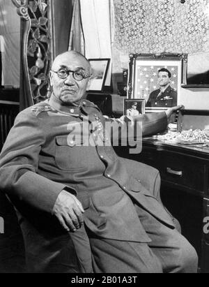 China: Yan Xishan (8 October 1883 - 22 July 1960), Warlord of Shanxi Province (r. 1911-1949), posing with signed picture of Claire Chennault, 1948.  Yan Xishan, (Wade–Giles: Yen Hsi-shan) was a Chinese warlord who served in the government of the Republic of China. Yan effectively controlled the province of Shanxi from the 1911 Xinhai Revolution to the 1949 Communist victory. As the leader of a relatively small, poor, remote province, Yan Xishan survived the machinations of Yuan Shikai, the Warlord Era, the Nationalist Era, the Japanese invasion of China and the Chinese Civil War. Stock Photo