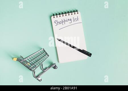Small trolley, paper notepad and pen, top view Stock Photo