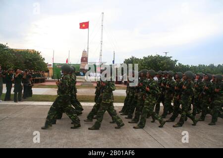 Vietnam: Vietnamese troops marching on Đảo Trường Sa or Spratly Island in the Spratly Islands, 1 May 2009.  The Spratly Islands are a group of more than 750 reefs, iislets, atolls, cays and islands in the South China Sea. The archipelago lies off the coasts of the Philippines and Malaysia (Sabah), about one third of the way to southern Vietnam. They comprise less than four square kilometres of land area spread over more than 425,000 square kilometres of sea. The Spratlys are one of three archipelagos of the South China Sea which comprise more than 30,000 islands and reefs. Stock Photo