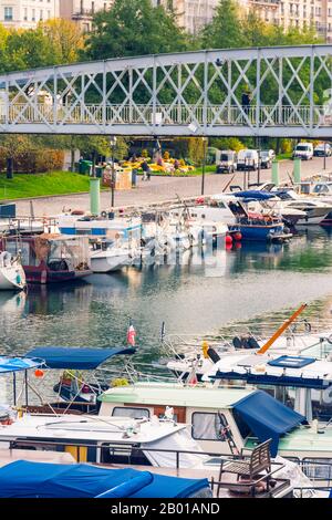 Paris, France - November 11, 2019: Boats in the port of Arsenal and the Mornay footbridge, near the Bastille Square Stock Photo