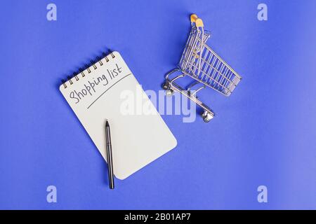 Small trolley, paper notepad and pen, top view Stock Photo