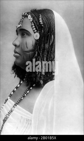 Sudan: Nubian woman, c. 1890-1923.  Nubia is a region along the Nile, in northern Sudan and southern Egypt.  There were a number of small Nubian kingdoms throughout the Middle Ages, the last of which collapsed in 1504, when Nubia became divided between Egypt and the Sennar sultanate resulting in the Arabization of much of the Nubian population. Nubia was again united within Ottoman Egypt in the 19th century, and within Anglo-Egyptian Sudan from 1899 to 1956.  The name Nubia is derived from that of the Noba people, nomads who settled the area in the 4th century. Stock Photo