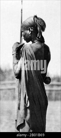 Sudan/South Sudan: A Shilluk or Chollo warrior. Photo by Hugo Adolf Bernatzik (26 March 1897 - 9 March 1953), 1930.  The Shilluk, who prefer to be known as Chollo, are a major Nilotic ethnic group of southern Sudan, living on both banks of the river Nile, in the vicinity of the city of Malakal. The most extensive Chollo area is located on the western bank of the Nile north from Malakal. Before the second Sudanese civil war the Chollo also lived in a number of settlements on the northern bank of the Sobat river.  The Shilluk are the third largest minority ethnic group of southern Sudan. Stock Photo