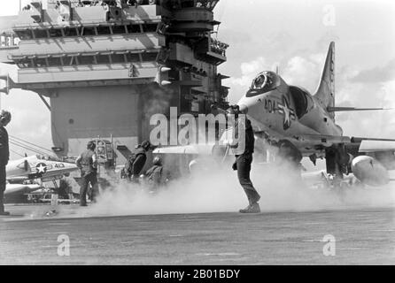 Vietnam/USA: Steam rises from the catapult as an A-4 Skyhawk attack aircraft is readied for launching from the flight deck of the  USS John F. Kennedy, Gulf of Tonkin, c. 1967.  The Second Indochina War, known in America as the Vietnam War, was a Cold War era military conflict that occurred in Vietnam, Laos, and Cambodia from 1 November 1955 to the fall of Saigon on 30 April 1975. This war followed the First Indochina War and was fought between North Vietnam, supported by its communist allies, and the government of South Vietnam, supported by the U.S. and other anti-communist nations. Stock Photo