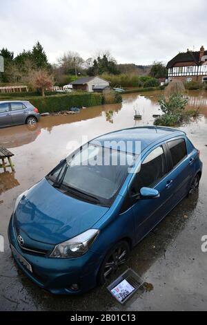 NUMBER PLATE PIXELATED BY PA PICTURE DESK A car surrounded by flood water in a back garden, Monmouth, in the aftermath of Storm Dennis. Stock Photo
