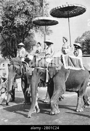 Vietnam: The Trung Sisters (Hai Ba Trung) Parade in Saigon, 26 April 1957.  Two Vietnamese women on elephant back represent the celebrated Trung Sisters (Hai Ba Trung) in the annual Hai Ba Trung Parade, Saigon, 26 April 1957.  The Trưng Sisters (c. 12-43 CE), known in Vietnamese as Hai Bà Trưng (literally 'the two Trưng Ladies'), and individually as Trưng Trắc and Trưng Nhị, were two first century Vietnamese women leaders from North Vietnam who successfully rebelled against Chinese Han Dynasty rule for three years, and are regarded as national heroines of Vietnam. Stock Photo