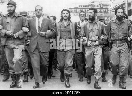 Cuba: 5 March 1960: Memorial service march for victims of the La Coubre explosion in Havana. On the far left of the photo is Fidel Castro, while in the centre is Che Guevara.  The freighter La Coubre exploded at 3:10 p.m. on 4 March 1960, while it was being unloaded in Havana harbour, Cuba. This 4,310-ton French vessel was carrying 76 tons of Belgian munitions from the port of Antwerp. Unloading explosive ordnance directly onto the dock was against port regulations. Ships with such cargoes were supposed to be moored in the centre of the harbour and their high-risk cargo unloaded onto lighters. Stock Photo