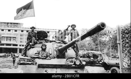 Vietnam: Tank of the North Vietnamese Army flying the NLF flag at the Presidential Palace (now Reunification Palace, Saigon, April 1975.  The Fall of Saigon was the capture/liberation of Saigon, the capital of South Vietnam, by the People's Army of Vietnam and the National Liberation Front on April 30, 1975. The event marked the end of the Vietnam War and the start of a transition period leading to the formal reunification of Vietnam under communist rule. Stock Photo